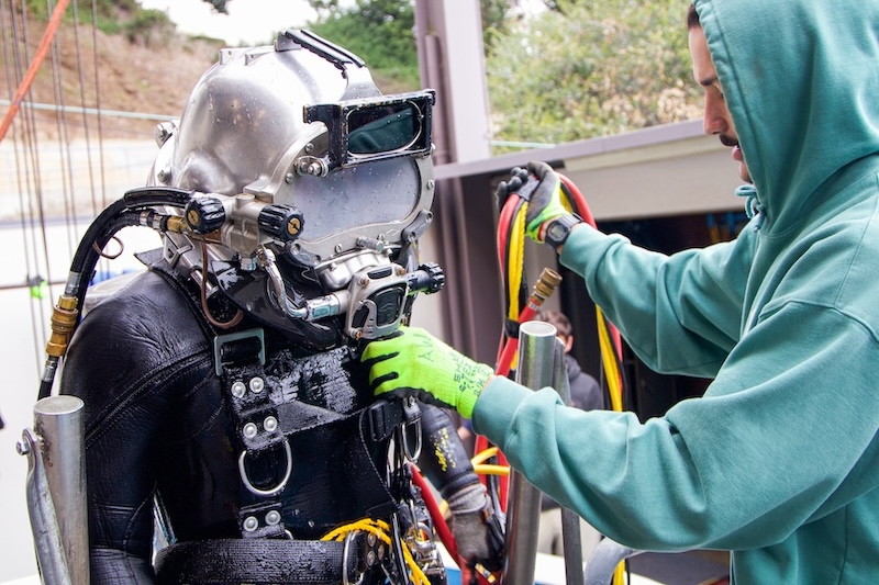 diver being tended at tank