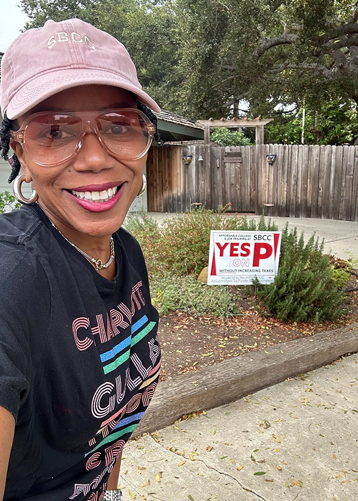 SBCC Trustee Charlotte Gullap-Moore with a Measure P sign