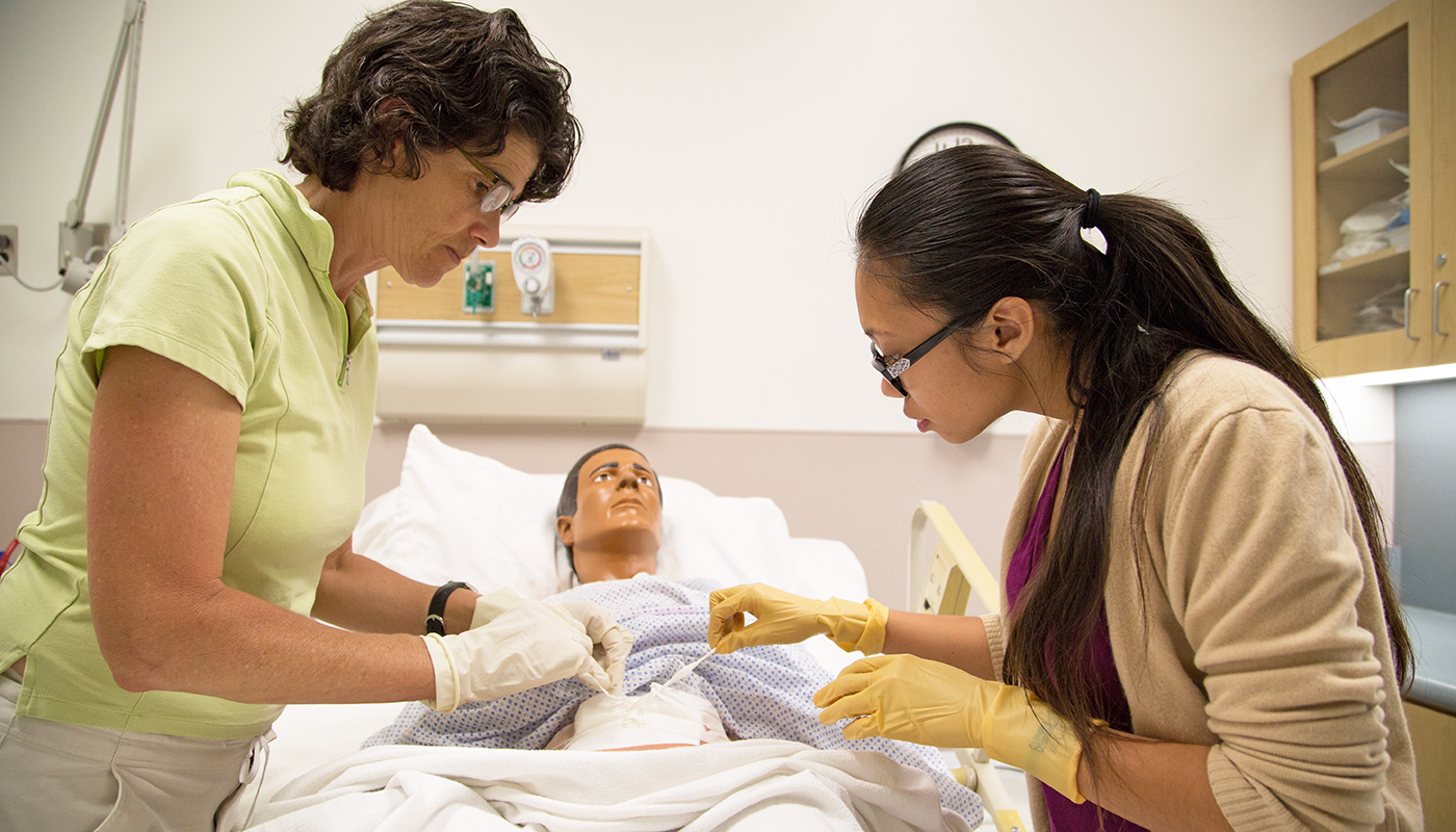 Two SBCC nursing students with a dummy.